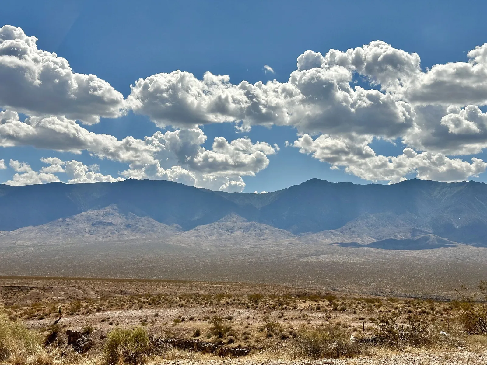 An open desert road beneath a blue sky